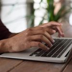 person using macbook 150x150.jpg