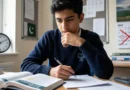 A student studying with a calendar showing May 15 crossed out, representing the postponed A-Level Maths paper in Pakistan.