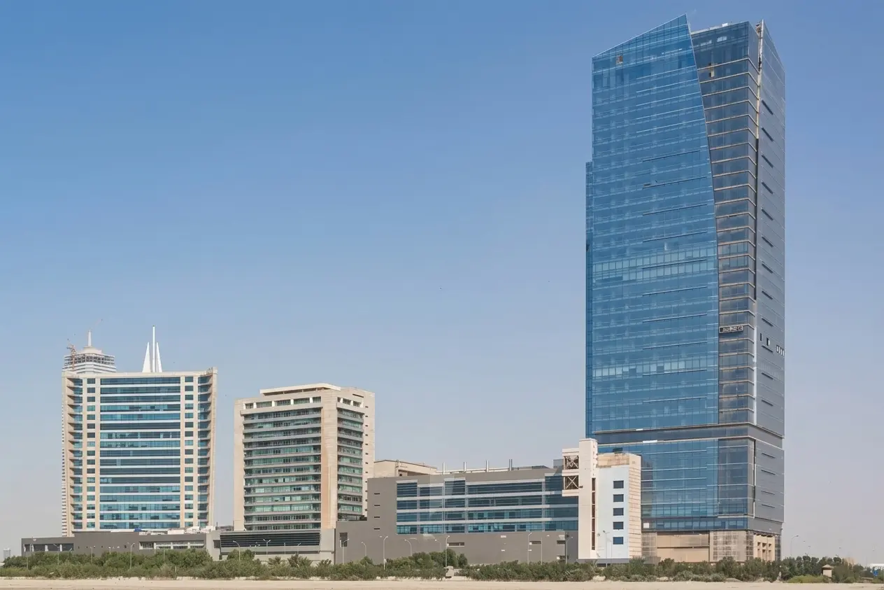 Dolmen City Towers complex in Clifton Karachi showing corporate skyscrapers and shopping mall under a clear blue sky