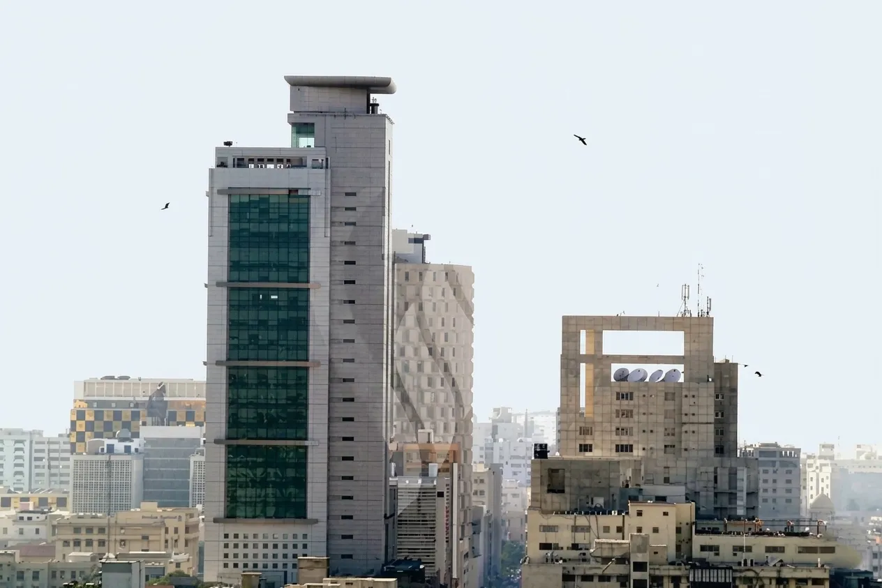 MCB Tower building on I.I. Chundrigar Road Karachi with a professional green glass facade under a clear daylight sky