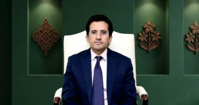 Federal Minister for Petroleum Ali Pervaiz Malik sitting in a professional setting with a green background