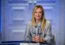 Italian Prime Minister Giorgia Meloni sitting confidently, representing her record-breaking long-term government.